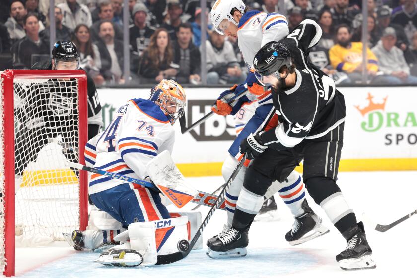 LOS ANGELES, CALIFORNIA - APRIL 26: Kings Phillip Danault tries to get a shot on goal as Oilers goalie Stuart Skinner and Vincent Desharnais defend in the first period in game 3 of the first round of the Stanley Cup Finals. (Wally Skalij/Los Angeles Times)