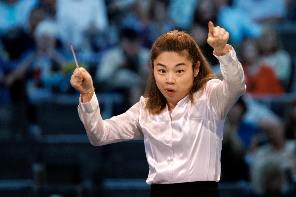 Elim Chan raises her baton.