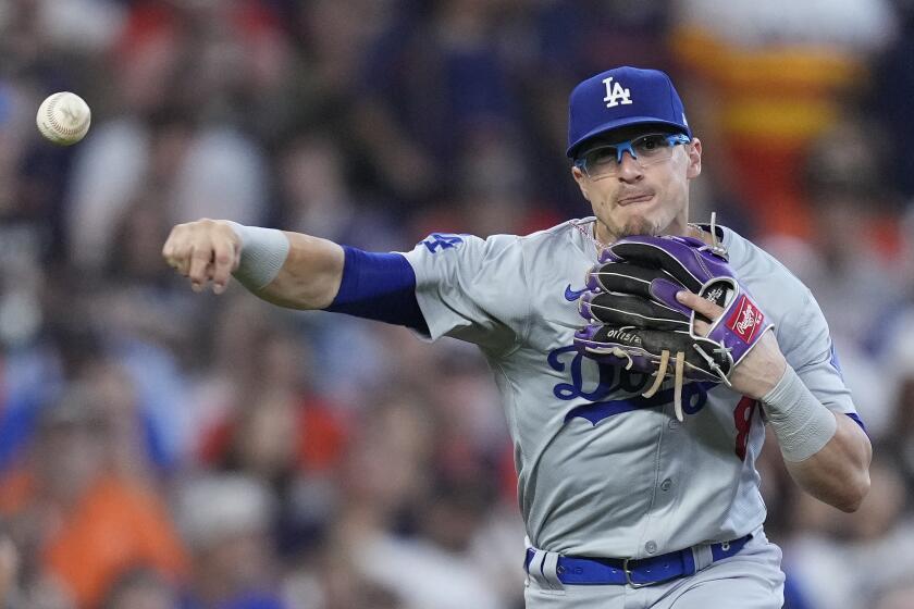 Los Angeles Dodgers third baseman Kiké Hernández fields a ground ball hit by Houston Astros' Jake Meyers during the seventh inning of a baseball game Sunday, July 28, 2024, in Houston. (AP Photo/Kevin M. Cox)