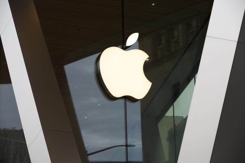 FILE - In this Saturday, March 14, 2020 file photo, an Apple logo adorns the facade of the downtown Brooklyn Apple store in New York. Apple is heading into a trial that threatens to upend the app store that brings in billions of dollars each year while feeding the more than 1.6 billion iPhones, iPads, and other devices at the core of its digital empire. The federal court case is being brought by Epic Games, the maker of the popular video Fortnite video game, in an attempt to topple the so-called “walled garden” that Apple has painstakingly built around its products. (AP Photo/Kathy Willens, File)