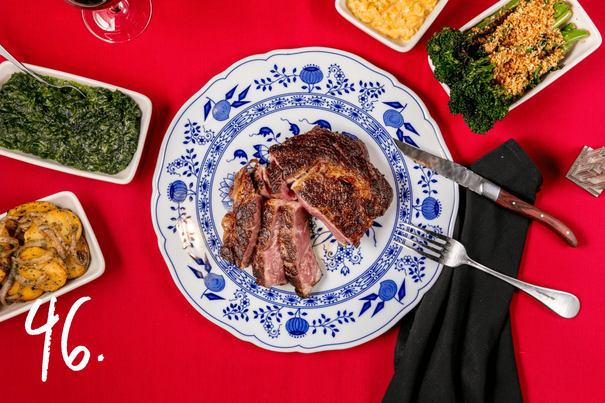 #46: An 18-ounce rib eye, with sides of german potatoes, broccolini, creamed corn, and creamed spinach 