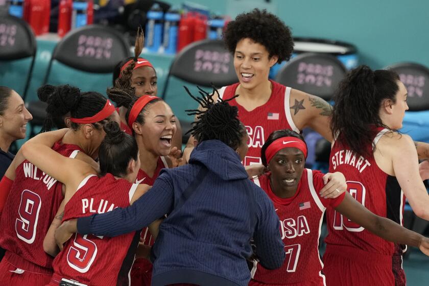 The United States team celebrates after a women's gold medal basketball game at Bercy Arena.