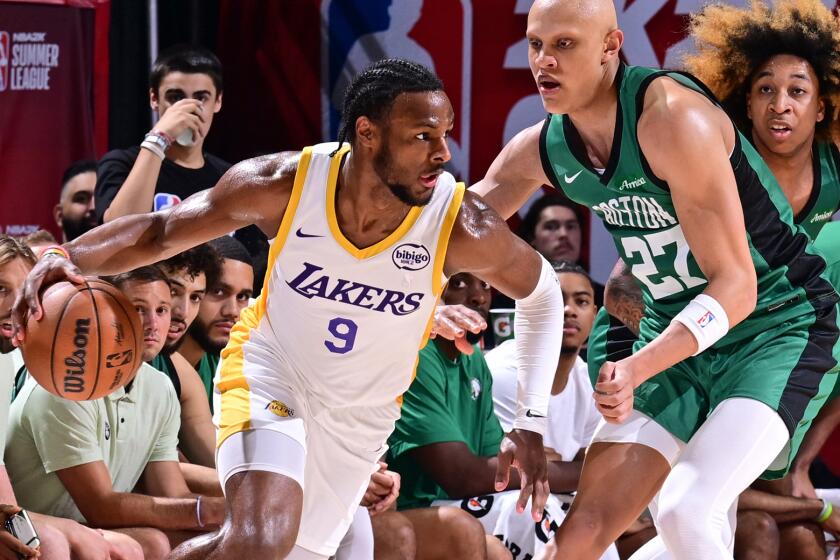 Bronny James Jr. of Los Angeles Lakers dribbles the ball during the game against the Boston Celtics