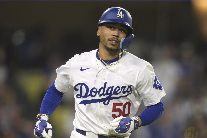 Los Angeles Dodgers' Mookie Betts runs to first base during a baseball game.