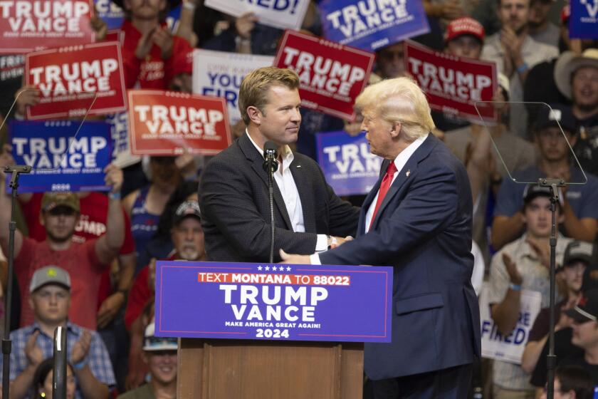 Republican Senate candidate Tim Sheehy shakes hands with Republican presidential nominee former President Donald Trump at a campaign rally in Bozeman, Mont., Friday, Aug. 9, 2024. (AP Photo/Janie Osborne)