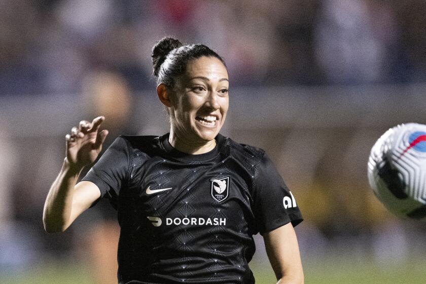 Angel City FC forward Christen Press chases a ball against San Diego during the 2022 season