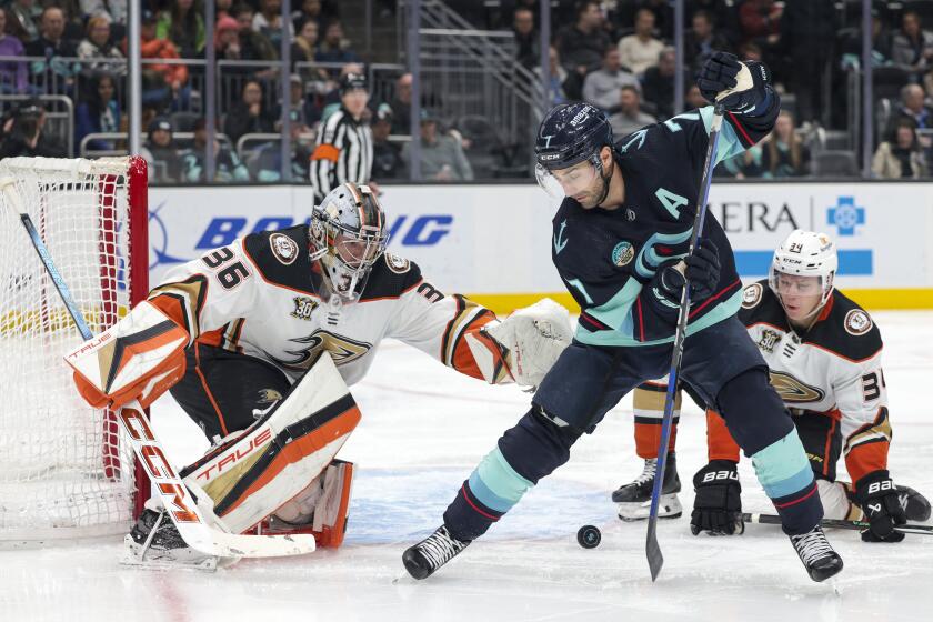 Seattle Kraken right wing Jordan Eberle (7) tries to score on Anaheim Ducks goaltender John Gibson (36) as defenseman Pavel Mintyukov (34) defends during the third period of an NHL hockey game Tuesday, March 26, 2024, in Seattle. (AP Photo/Jason Redmond)