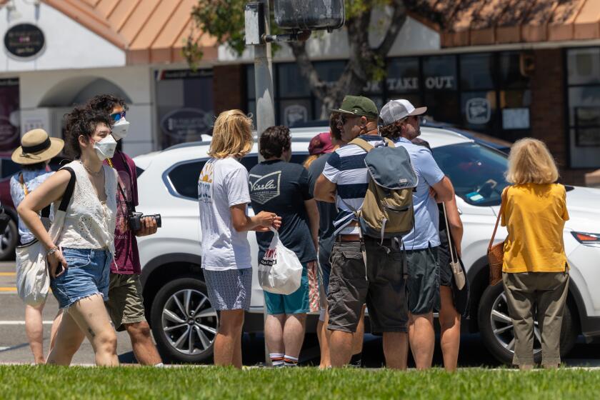 Laguna Beach, CA - July 28: Individuals walk along Laguna Beach, CA on Sunday, July 28, 2024. (Zoe Cranfill / Los Angeles Times)