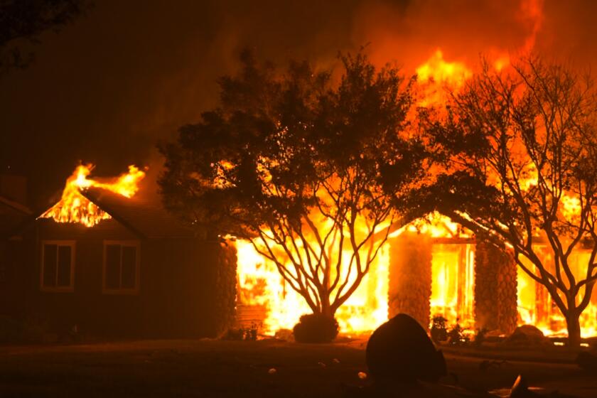 The Park Fire burns a building off Cohasset Rd. in Chico, Calif. on July 25, 202