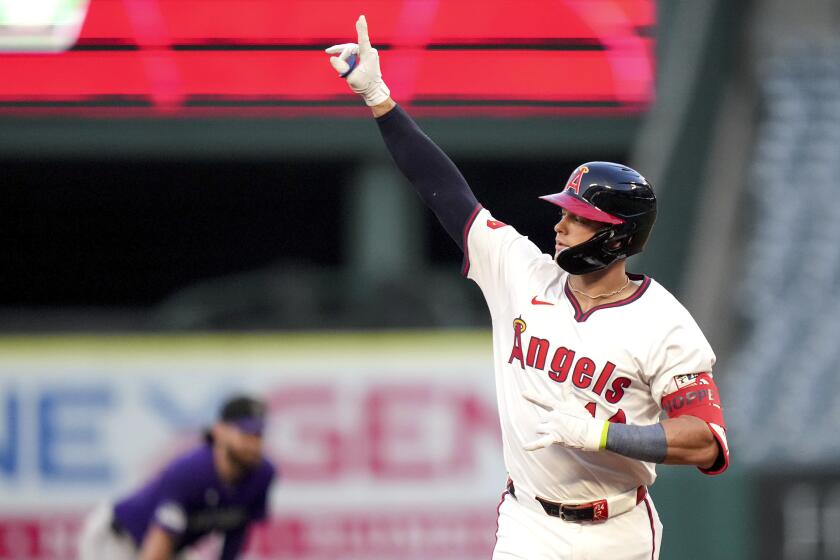 Los Angeles Angels' Logan O'Hoppe celebrates while running the bases after hitting a home run during the fourth inning of a baseball game against the Colorado Rockies in Anaheim, Calif., Thursday, Aug. 1, 2024. (AP Photo/Eric Thayer)