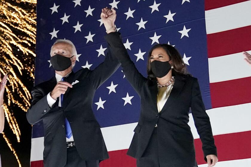 FILE - Democratic presidential candidate former Vice President Joe Biden, left, and his running mate Sen. Kamala Harris, D-Calif., watch fireworks during the fourth day of the Democratic National Convention, Aug. 20, 2020, in Wilmington, Del. Harris, the daughter of immigrants who rose through the California political and law enforcement ranks to become the first female vice president in U.S. history, is poised to secure the Democratic Party's presidential nomination Monday, Aug. 5, 2024. (AP Photo/Andrew Harnik, File)