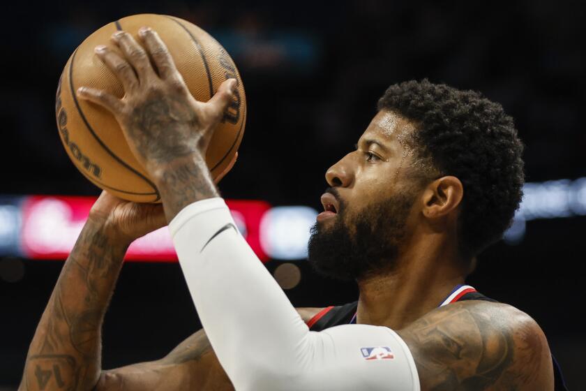 A closeup of Clippers forward Paul George aiming to take a shot.