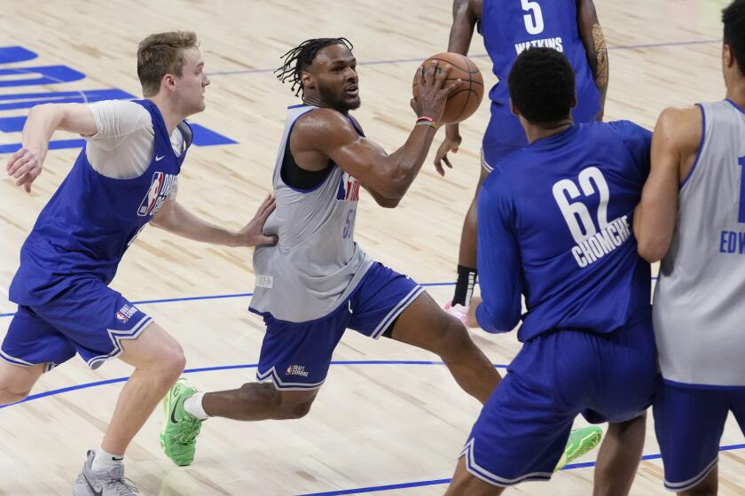 Bronny James drives past Cam Spencer during the NBA draft combine in Chicago on May 14