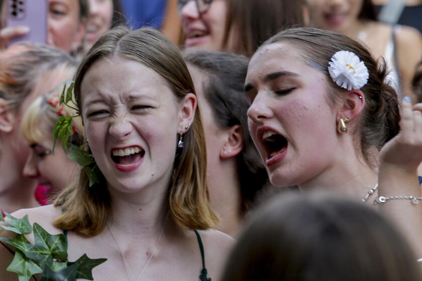 Swifties sing and dance in Vienna on Friday, Aug.9, 2024. Organizers of three Taylor Swift concerts in the stadium in Vienna this week called them off on Wednesday after officials announced arrests over an apparent plot to launch an attack on an event in the Vienna area such as the concerts. (AP Photo/Heinz-Peter Bader)