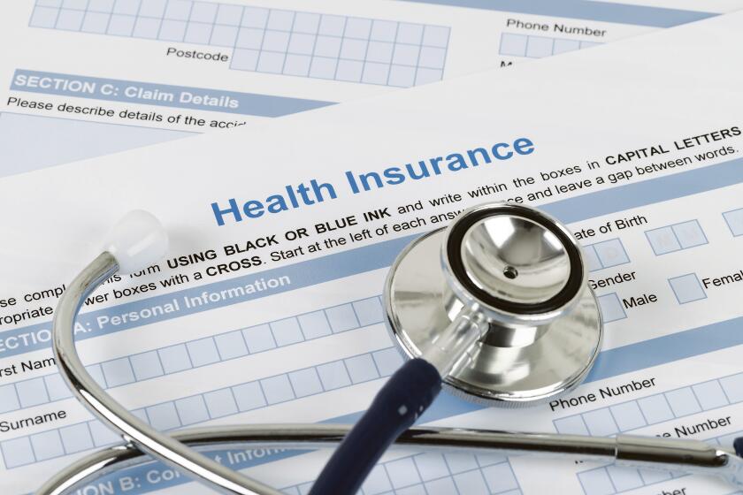 Health insurance application form with stethoscope and calculator