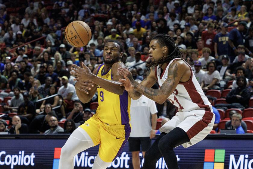 Bronny James is fouled by Cleveland forward Emoni Bates in the first half.