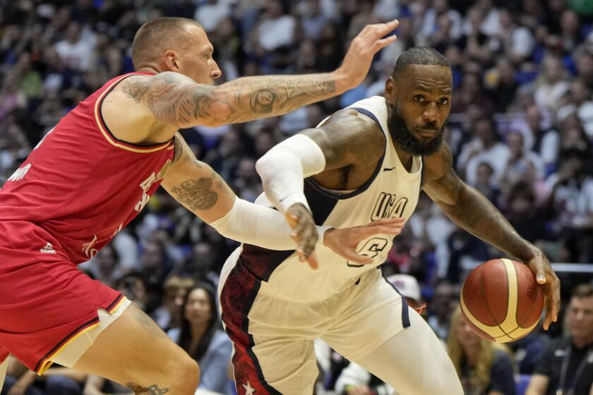 Germany's forward Daniel Theis, left, blocks United States' forward LeBron James.