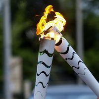 Corfu, Greece - April 23, 2016: The Olympic flame is symbolically passed from one torch to another after the official ceremonial lighting