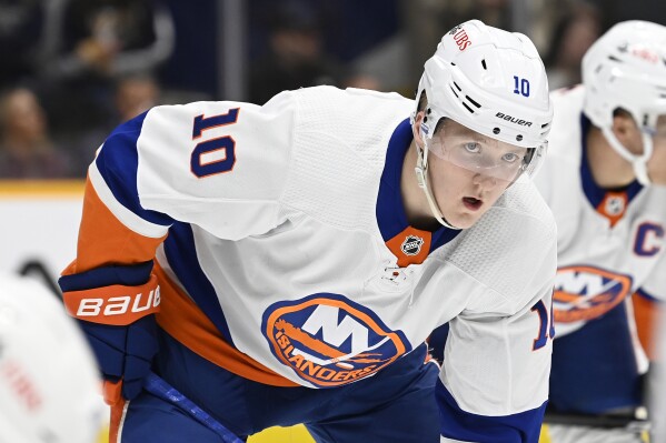 FILE - New York Islanders right wing Simon Holmstrom (10) plays against the Nashville Predators during the second period of an NHL hockey game, Jan. 13, 2024, in Nashville, Tenn. The Islanders have signed Holmstrom to a one-year contract. The team announced the signing with the 23-year-old restricted free agent from Sweden on Tuesday, July 16. (AP Photo/Mark Zaleski, file)