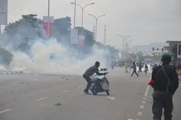 FILE - Police fired tear gas during a protest in Abuja, Nigeria, Thursday, Aug. 1, 2024. Nigerian security forces on Saturday, Aug. 3, 2024, fired bullet rounds and teargas at several journalists and protesters during demonstrations against the country’s economic crisis in the capital city, according to the journalists and videos of the incident reviewed by The Associated Press. (AP Photo/Olamikan Gbemiga, File)