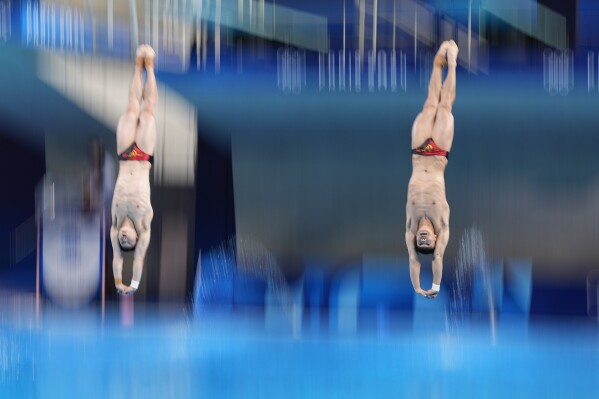 China's Long Daoyi and Wang Zongyuan compete in the men's synchronised 3m springboard diving final at the 2024 Summer Olympics, Friday, Aug. 2, 2024, in Saint-Denis, France. (AP Photo/Lee Jin-man)