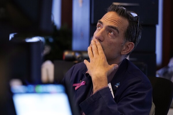 Trader Gregory Rowe works on the floor of the New York Stock Exchange, Monday, Aug. 5, 2024. (AP Photo/Richard Drew)