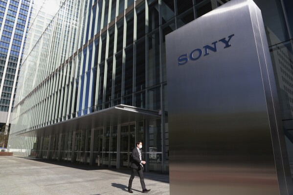 FILE - A man walks past the headquarters of Sony Corp. in Tokyo, on Feb. 3, 2021. (AP Photo/Koji Sasahara, File)