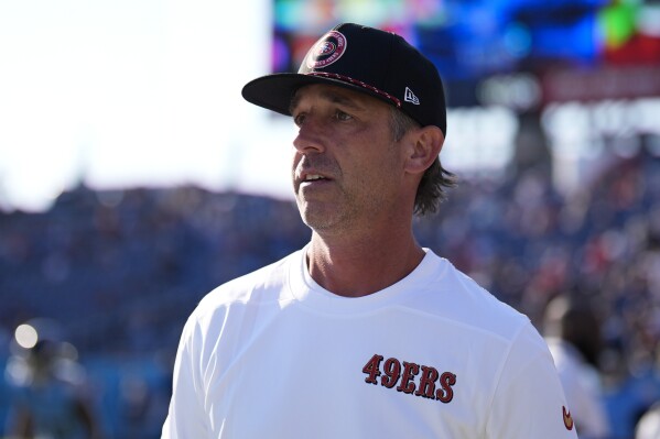 San Francisco 49ers head coach Kyle Shanahan watches as his team warms up before an NFL preseason football game against the Tennessee Titans, Saturday, Aug. 10, 2024, in Nashville, Tenn. (AP Photo/Mike Stewart)