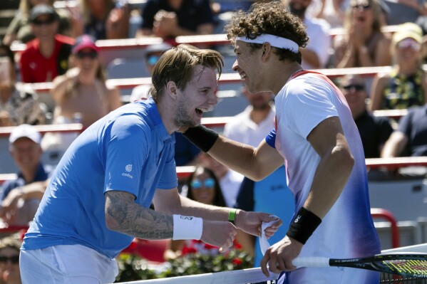 United States' Ben Shelton, right, and Kazakhstan's Alexander Bublik embrace after their match at the National Bank Open tennis tournament, Wednesday, Aug. 7, 2024 in Montreal. (Ryan Remiorz/The Canadian Press via AP)