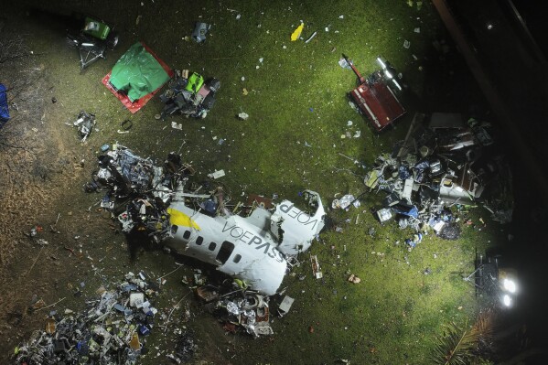 The debris at the site where an airplane crashed with 61 people on board, in Vinhedo, Sao Paulo state, Brazil, early on Saturday, Aug. 10, 2024. Brazilian authorities are working to piece together what exactly caused the plane crash in Sao Paulo state the previous day, killing all 61 people aboard. (AP Photo/Andre Penner)