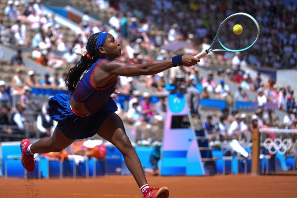 Coco Gauff of United States returns a shot to Donna Vekic of Croatia during their women's singles third round match at the Roland Garros stadium, at the 2024 Summer Olympics, Tuesday, July 30, 2024, in Paris, France. (AP Photo/Andy Wong)