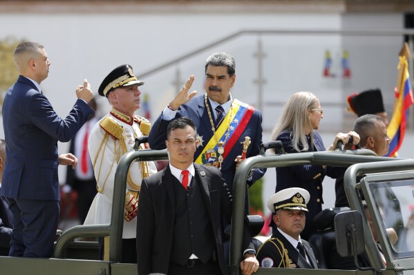 President Nicolas Maduro waves while riding in the back of a military vehicle during an Independence Day parade in Caracas, Venezuela, Friday, July 5, 2024. Venezuela is marking 213 years of independence from Spain. (AP Photo/Cristian Hernandez)