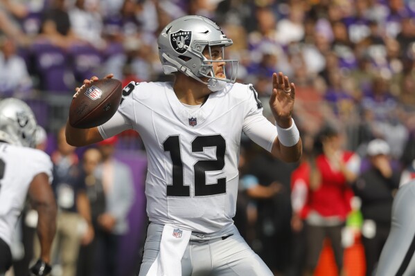 Las Vegas Raiders quarterback Aidan O'Connell (12) throws against the Minnesota Vikings during the first half of an NFL football game Saturday, Aug. 10, 2024, in Minneapolis. (AP Photo/Bruce Kluckhohn)