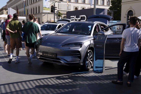 File - Visitors watch a BYD Seal U car at the IAA motor show in Munich, Germany, Friday, Sept. 8, 2023. (AP Photo/Matthias Schrader, File)