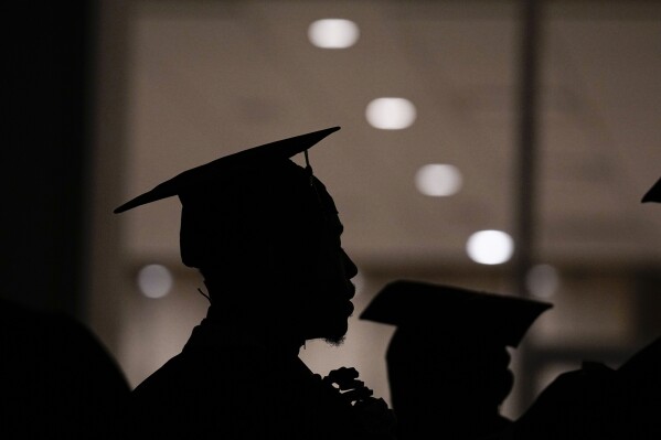 FILE - A Morehouse College student lines up before the school commencement, May 19, 2024, in Atlanta. With graduation season over, many college grads are embarking on summer internships or their first full-time jobs.(AP Photo/Brynn Anderson, File)