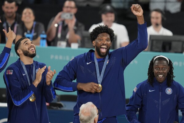 United States' Joel Embiid (11) celebrates after winning a men's gold medal basketball game against France at Bercy Arena at the 2024 Summer Olympics, Saturday, Aug. 10, 2024, in Paris, France. (AP Photo/Michael Conroy)