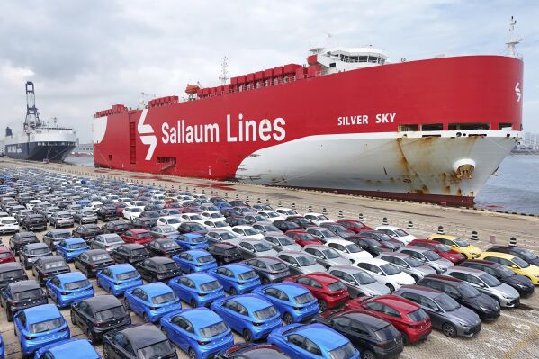 FILE -New cars wait for transportation near a Sallaum Lines ro-ro ship seen by the dock in Yantai in east China's Shandong province on Tuesday, Aug. 6, 2024. (Chinatopix via AP, File)