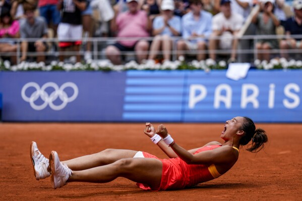 Qinwen Zheng of China celebrates her victory over Iga Swiatek of Poland during their women's semifinals match at the Roland Garros stadium, at the 2024 Summer Olympics, Thursday, Aug. 1, 2024, in Paris, France. (AP Photo/Manu Fernandez)