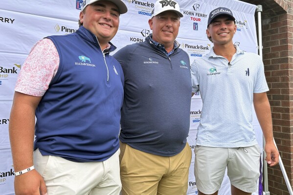 Scott Gutschewski is flanked by his sons, Luke, left, and Trevor ahead of the Korn Ferry Tour’s Pinnacle Bank Championship golf tournament, Tuesday, Aug. 6, 2024, in Omaha, Neb. (AP Photo/Eric Olson)