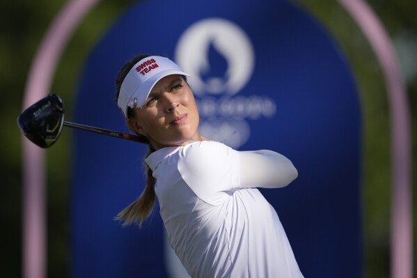 Morgane Metraux, of Switzerland, hits her shot from the 4th tee during the second round of the women's golf event at the 2024 Summer Olympics, Thursday, Aug. 8, 2024, at Le Golf National, in Saint-Quentin-en-Yvelines, France. (AP Photo/George Walker IV)