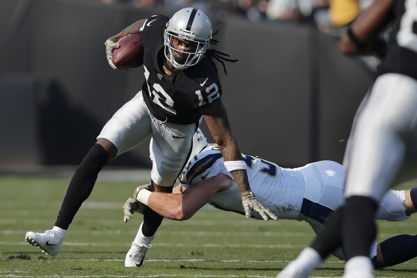 FILE - Oakland Raiders wide receiver Martavis Bryant (12) runs against Los Angeles Chargers linebacker Kyle Emanuel during the first half of an NFL football game in Oakland, Calif., Nov. 11, 2018. (AP Photo/John Hefti, File)