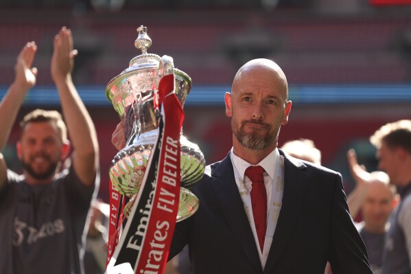 FILE - Manchester United's head coach Erik ten Hag celebrates with the trophy after winning the English FA Cup final soccer match between Manchester City and Manchester United at Wembley Stadium in London, on May 25, 2024. (AP Photo/Ian Walton)