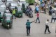 A police officer regulates a busy traffic intersection in Dhaka, Bangladesh, Monday, Aug. 12, 2024. (AP Photo/Rajib Dhar)