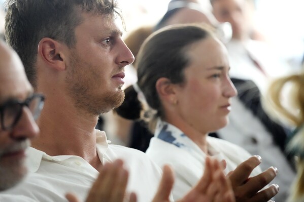 CORRECTS NAME TO TOM REUVENY NOT TOM REUVENI -I sraeli gold medalist windsurfer Tom Reuveny, left, and cyclist Rotem Gafinovitz, attend a ceremony in remembrance of the 11 Israeli athletes killed during the 1972 Munich Olympic Games, at the 2024 Summer Olympics, Tuesday, Aug. 6, 2024, in Paris, France. (AP Photo/David Goldman)