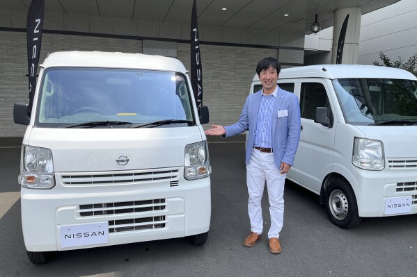 Susumu Miura, a Nissan Research Center manager, shows a Nissan car that is coated with the special “cool paint,” under testing at Tokyo’s Haneda airport Tuesday, Aug. 6, 2024. (AP Photo/Yuri Kageyama)