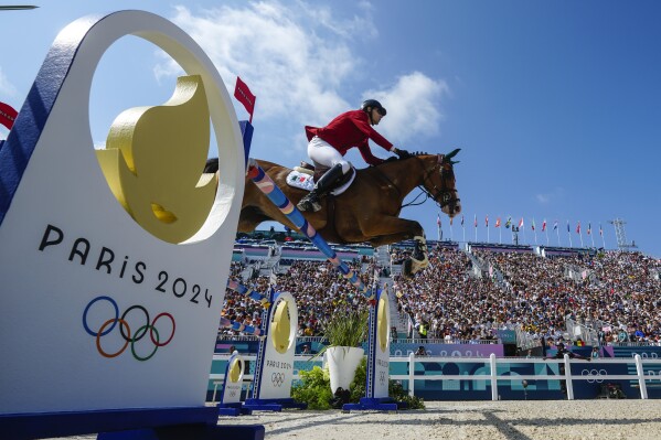 Mexico's Carlos Hank Guerreiro, riding H5 Porthos Maestro Wh Z, competes in the equestrian team jumping qualifier, at the 2024 Summer Olympics, Thursday, Aug. 1, 2024, in Versailles, France. (AP Photo/Mosa'ab Elshamy)