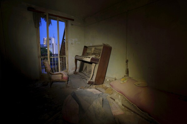 An abandoned piano is seen inside of an abandoned apartment in the war-torn UN buffer zone in divided capital Nicosia, Cyprus, Tuesday, June 18, 2024. Fifty years after war cleaved Cyprus along ethnic lines, re-emergent tensions along a 180 km-long United Nations controlled buffer zone separating breakaway Turkish Cypriots from Greek Cypriots in an internationally recognized south have revived concerns that this "frozen" conflict could become another source of instability in an already tumultuous region. (AP Photo/Petros Karadjias)