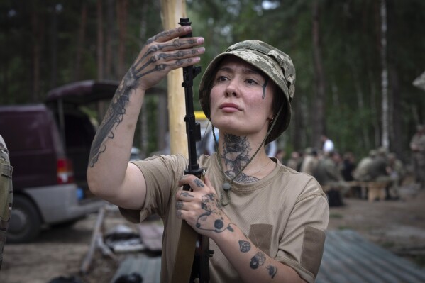 A volunteer of the woman mobile air defense group Bucha Witches practices combat training in Bucha region close to capital Kyiv, Ukraine, Saturday, Aug. 3, 2024. (AP Photo/Efrem Lukatsky)