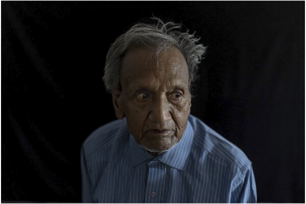 Suresh Prakash Agarwal stands for a portrait at the Saint Hardyal Educational and Orphans Welfare Society shelter where he is a resident in Garhmukteshwar, India, Thursday, April 18, 2024. Agarwal, 87, lost both his wife and his son in a landslide in 2013 while on a trek. The former law professor says their deaths left him “paralyzed with grief” and with no one else to help care for him. Looking to the home’s manager, 30-year-old Naved Khan, he says: “He is my guardian.” (AP Photo/David Goldman)