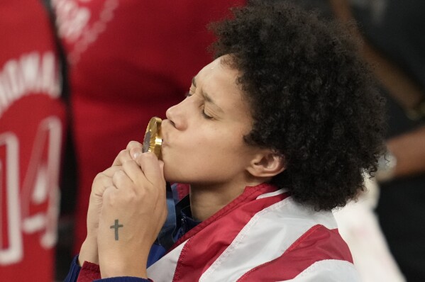 United States' Brittney Griner kisses her gold medal at Bercy Arena at the 2024 Summer Olympics, Sunday, Aug. 11, 2024, in Paris, France. (AP Photo/Michael Conroy)